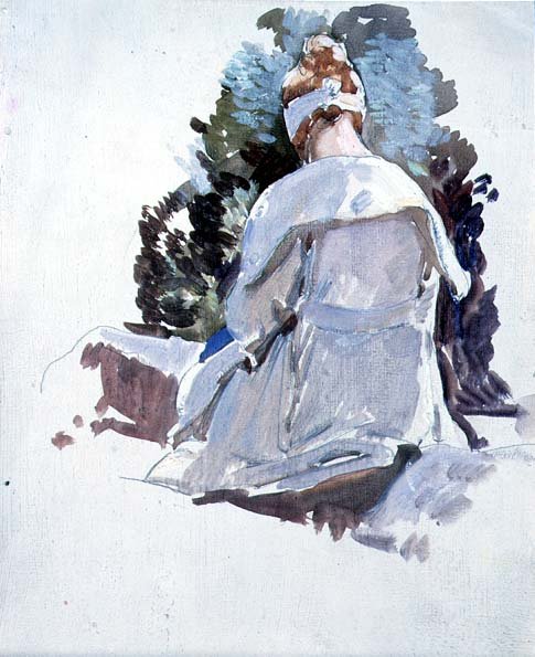 Woman in a white dress sitting upon rocks