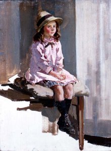 Portrait of a young girl in a pink dress and a straw hat